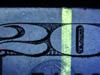 Detail of fluorescent strip and fluorescent fibers in a US $20 bill